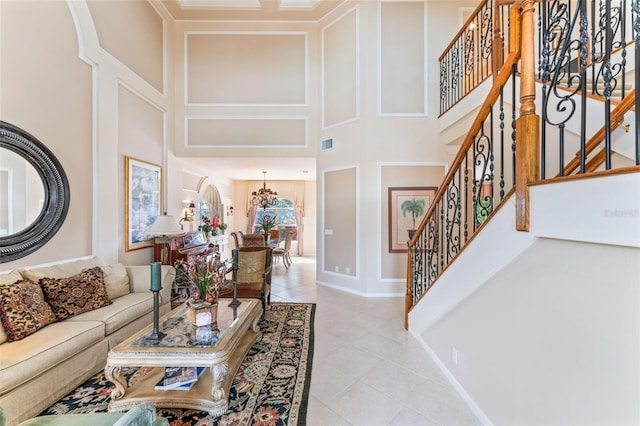 tiled living room with a notable chandelier and a high ceiling