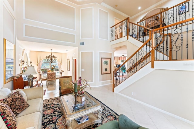 tiled living room with crown molding, a chandelier, and a high ceiling