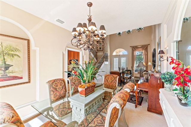 dining space with french doors, a chandelier, and light tile patterned floors