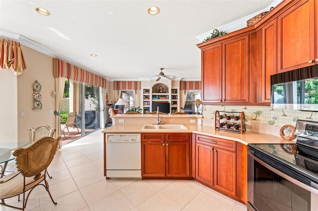 kitchen featuring stainless steel electric stove, sink, white dishwasher, kitchen peninsula, and crown molding