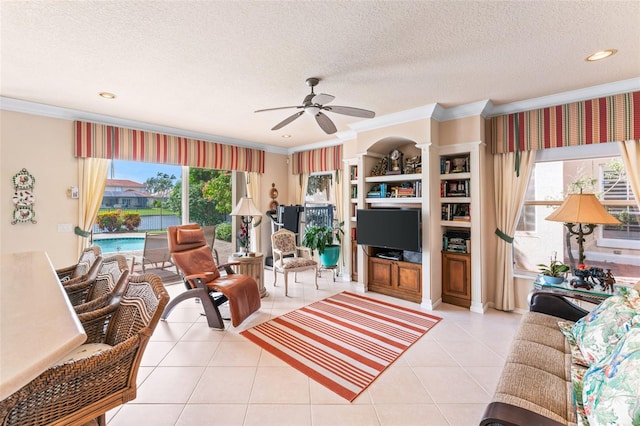 living room featuring crown molding, ceiling fan, a textured ceiling, and light tile patterned floors