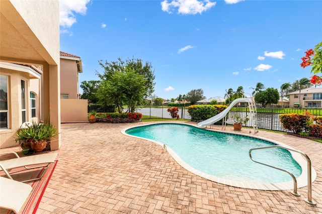 view of pool with a water slide and a patio