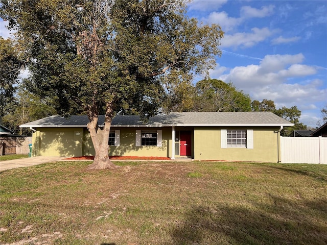 single story home with fence, a front lawn, and stucco siding