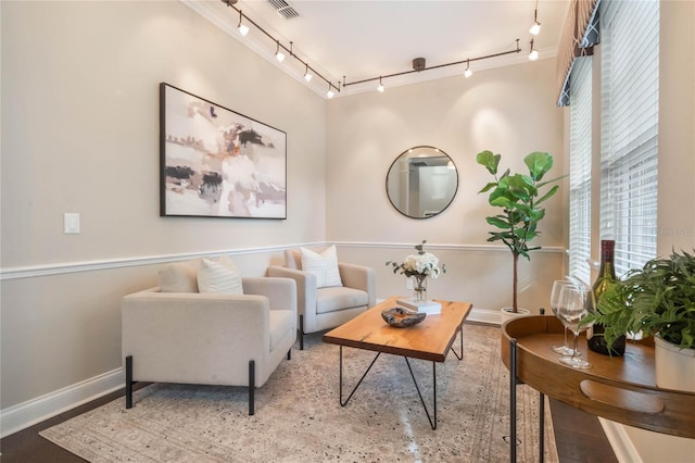 sitting room with hardwood / wood-style floors and rail lighting