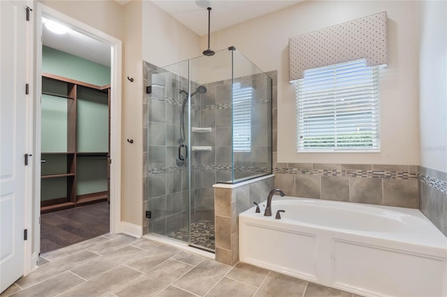 bathroom with shower with separate bathtub and wood-type flooring