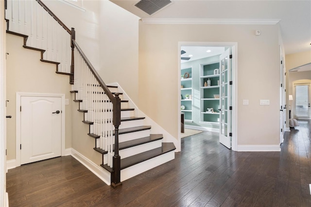 stairway with hardwood / wood-style floors and crown molding