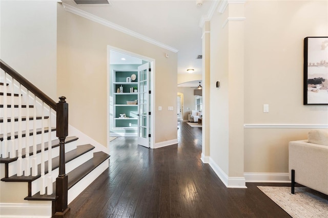 interior space with ornamental molding and dark hardwood / wood-style floors