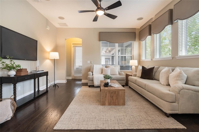 living room with dark wood-type flooring and ceiling fan