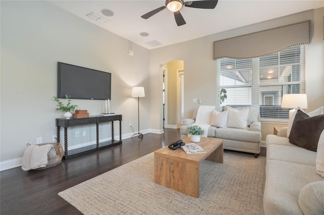 living room featuring dark hardwood / wood-style flooring and ceiling fan