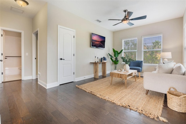 living room featuring dark hardwood / wood-style flooring and ceiling fan