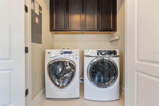 laundry room featuring cabinets, electric panel, light tile patterned flooring, and independent washer and dryer