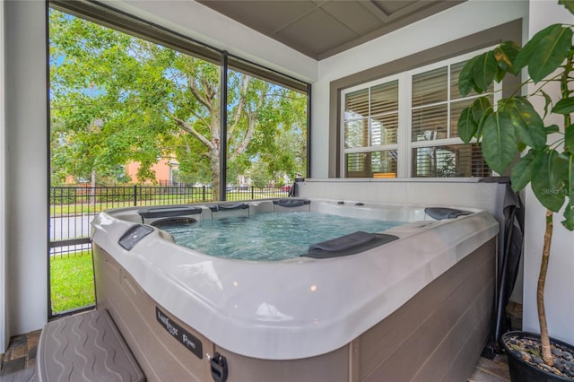 sunroom / solarium with a jacuzzi