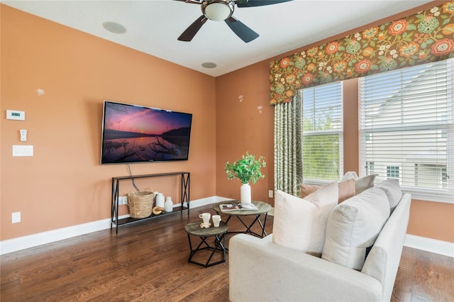 living room featuring ceiling fan and dark hardwood / wood-style floors