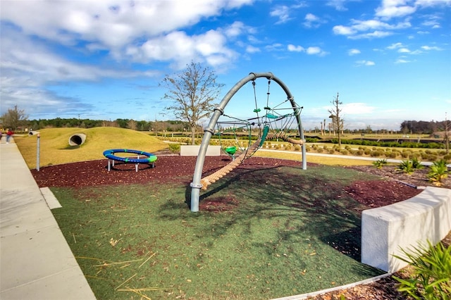 view of playground with a lawn