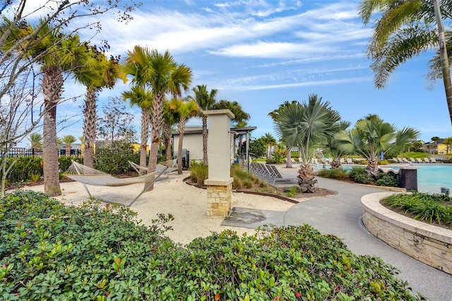 surrounding community featuring a swimming pool and a patio