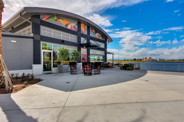 exterior space featuring a water view and a patio area