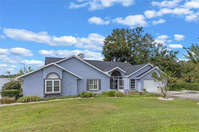 ranch-style house featuring a garage and a front yard