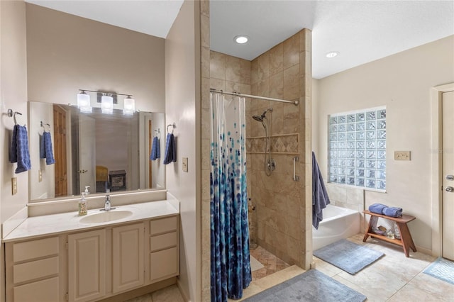 bathroom with tile patterned flooring, shower with separate bathtub, and vanity