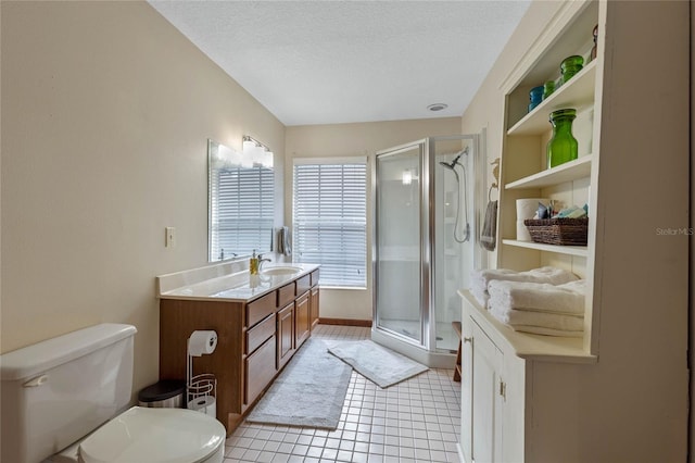 bathroom with vanity, a shower with door, a textured ceiling, and toilet