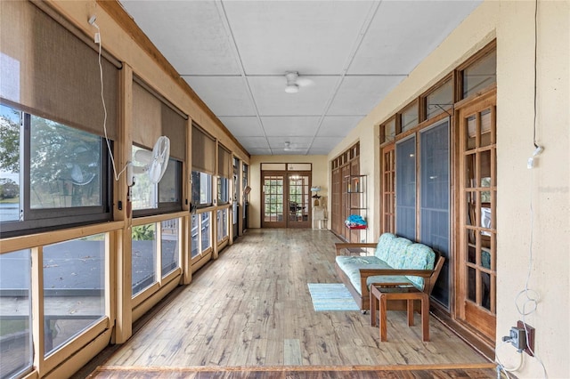 sunroom featuring a paneled ceiling, french doors, and a healthy amount of sunlight