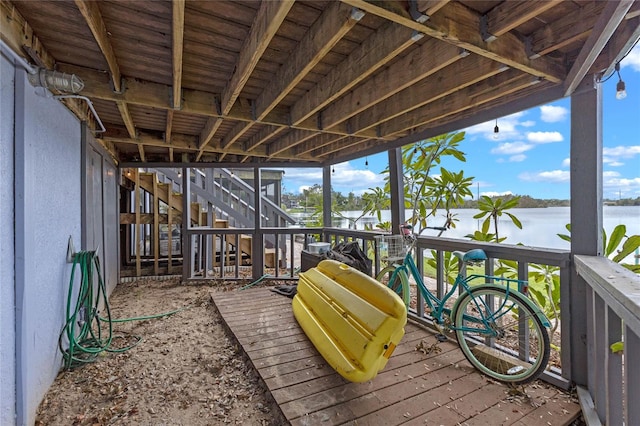 wooden terrace featuring a water view