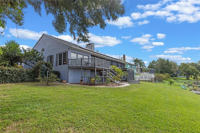 back of house with a yard and a deck