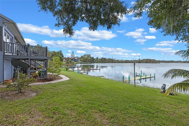 view of yard with a water view and a boat dock