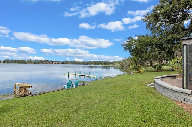 dock area with a yard and a water view