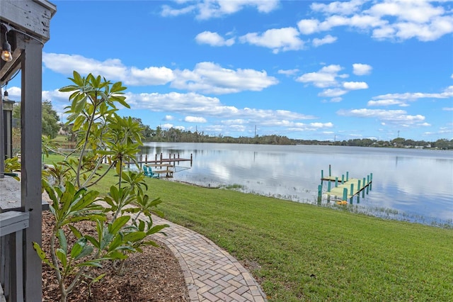 view of dock featuring a water view and a yard