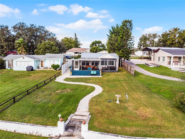 view of front of property featuring glass enclosure and a front yard