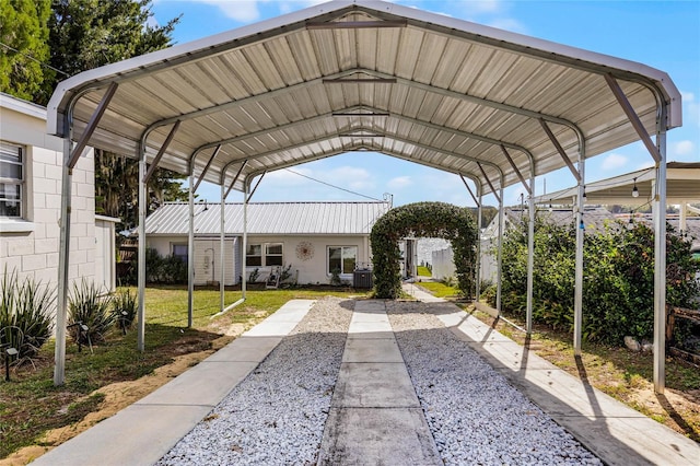 view of vehicle parking featuring a carport and a lawn