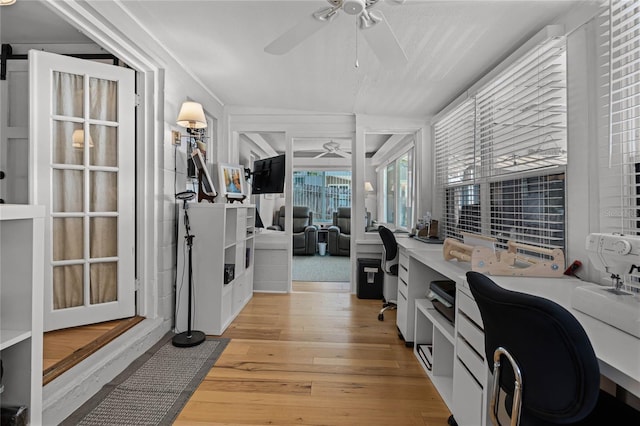 office featuring light hardwood / wood-style floors, ceiling fan, and lofted ceiling