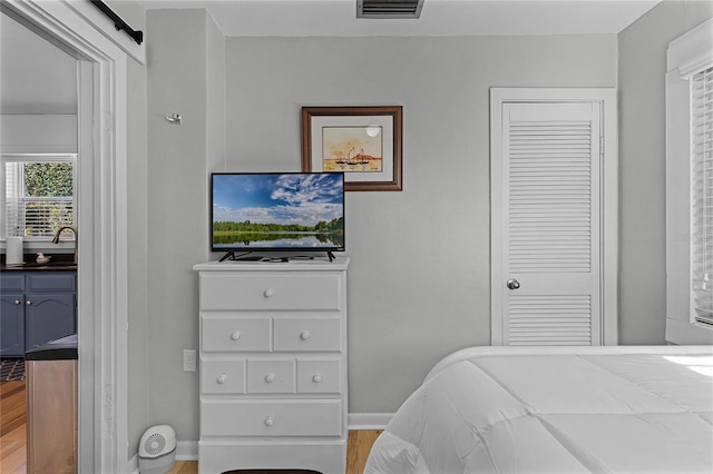 bedroom featuring sink and light wood-type flooring