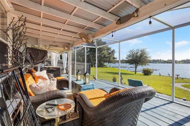 sunroom / solarium with plenty of natural light and a water view