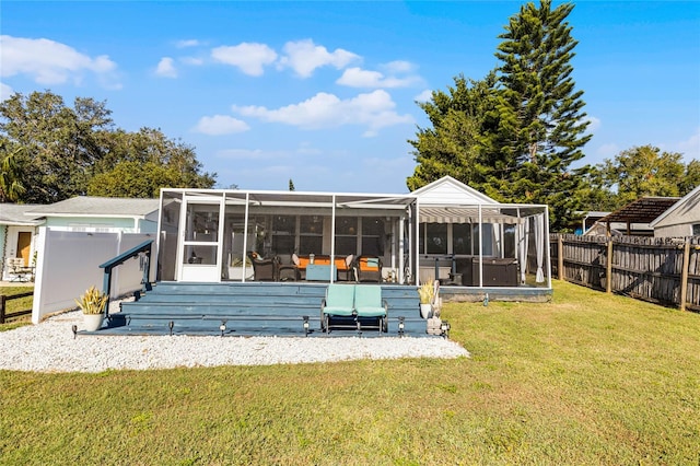 back of property with a lawn and a sunroom