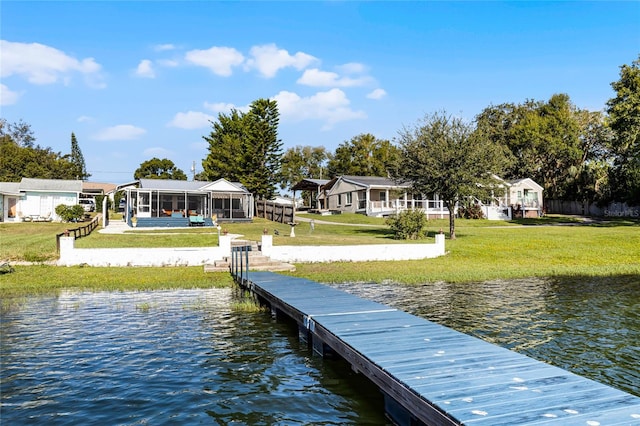 dock area with a water view and a yard