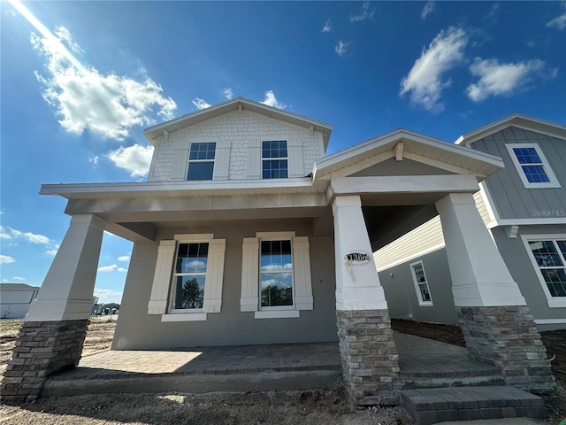 craftsman inspired home featuring covered porch