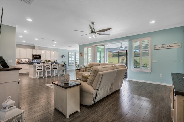 living room featuring dark hardwood / wood-style flooring, ceiling fan, and crown molding