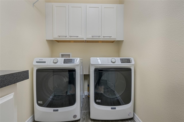 laundry room with cabinets and washer and clothes dryer