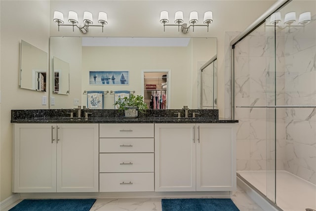 bathroom featuring walk in shower and vanity