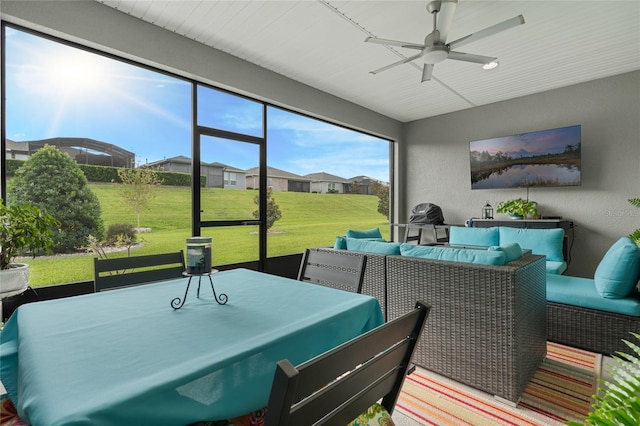 sunroom featuring ceiling fan