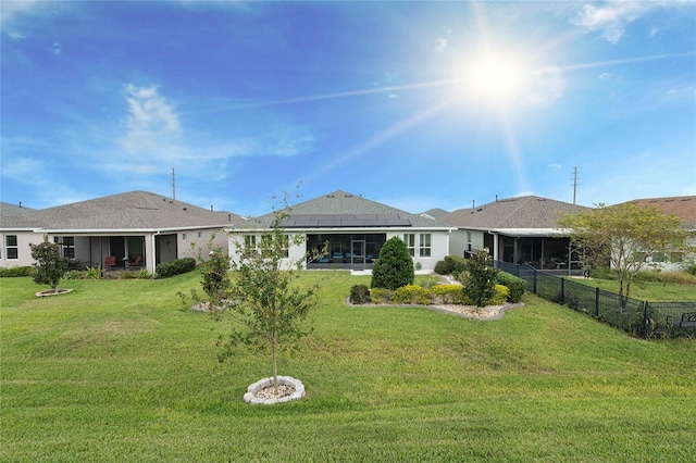 back of house with a sunroom and a yard