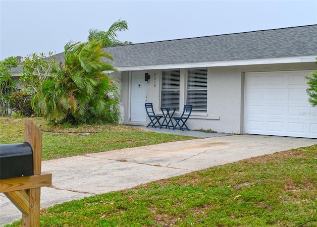 entrance to property with a yard and a garage