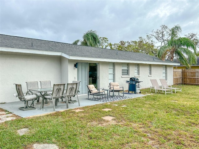 rear view of house featuring a yard and a patio