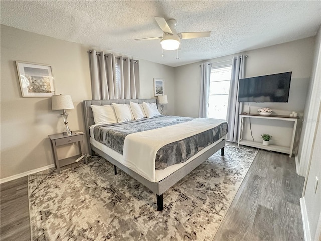 bedroom featuring wood-type flooring, a textured ceiling, and ceiling fan