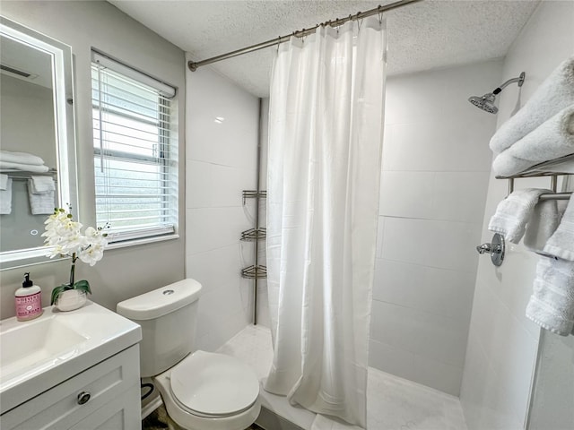 bathroom with a shower with curtain, toilet, a textured ceiling, and vanity