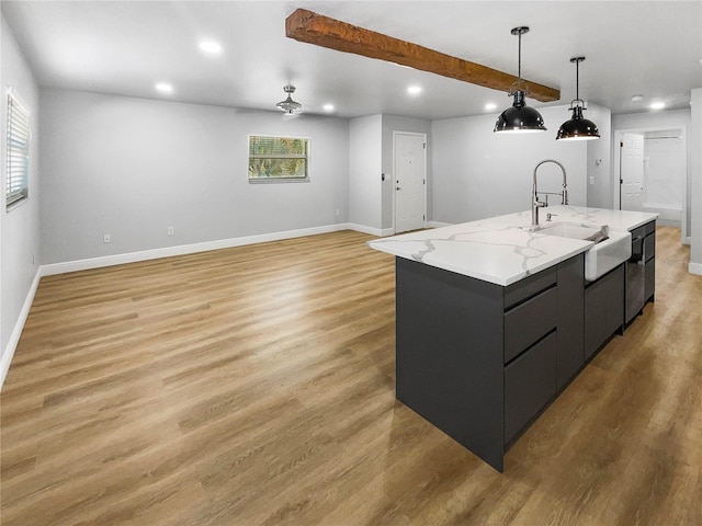 kitchen featuring a wealth of natural light, light hardwood / wood-style flooring, hanging light fixtures, and a spacious island