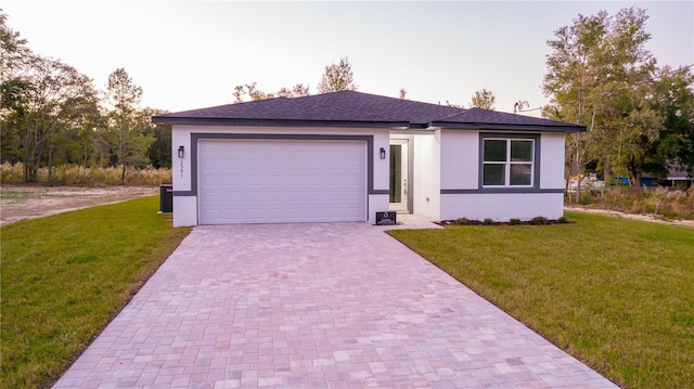 view of front of property with a garage and a front lawn