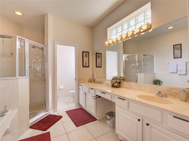 full bathroom with toilet, vanity, tile patterned floors, and separate shower and tub