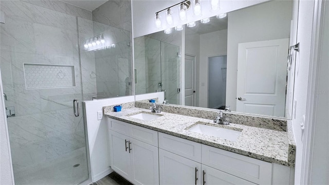 bathroom featuring vanity and a shower with shower door